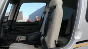 View of the interior of a Cirrus SR22T, focusing on the seats and side panel.