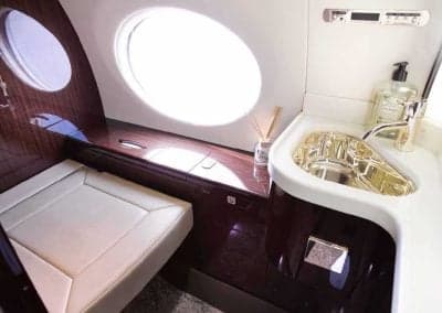 Aircraft lavatory with a sink and vanity.