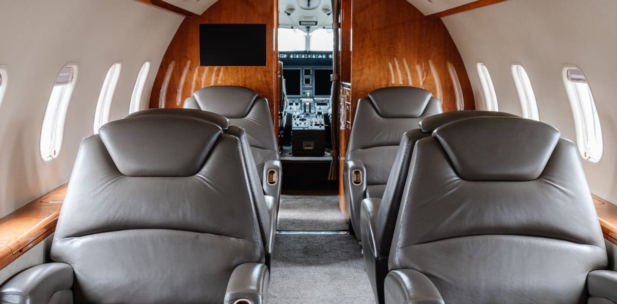 View of the cabin seats and cockpit of the aircraft.