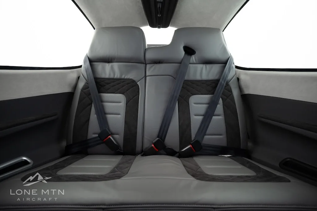 The gray and black quilted rear passenger seats of the Cirrus SR22T aircraft cabin.