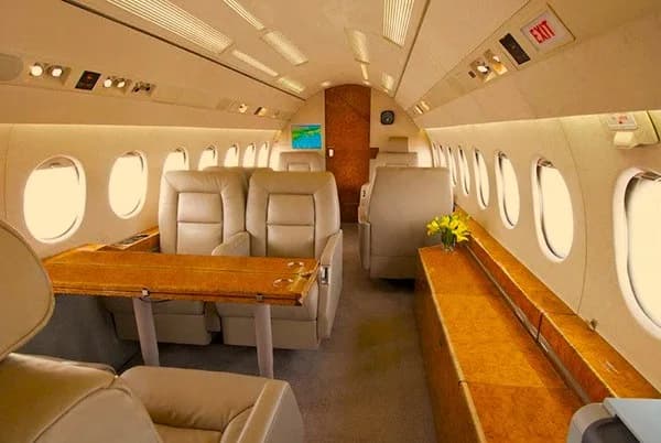 The interior of the aircraft features leather seats and wood accents.