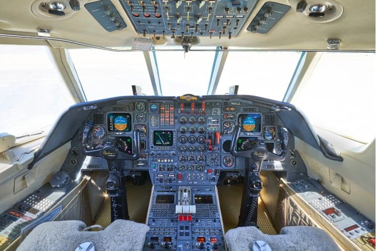 View of the aircraft cockpit with instrument panel and controls.