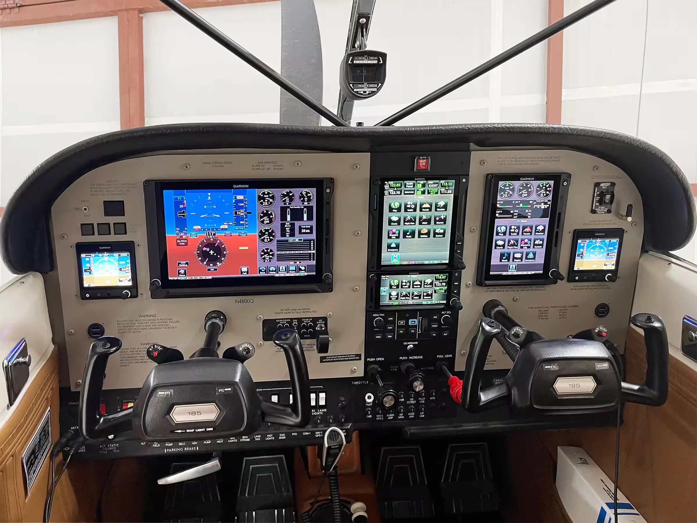 The cockpit of a Cessna 185 aircraft, N4800Q, featuring a modern glass panel with multiple Garmin displays.