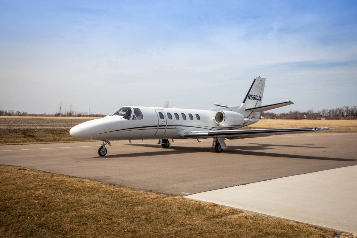 A Citation CJ3 aircraft with registration N560JA is parked on the tarmac.