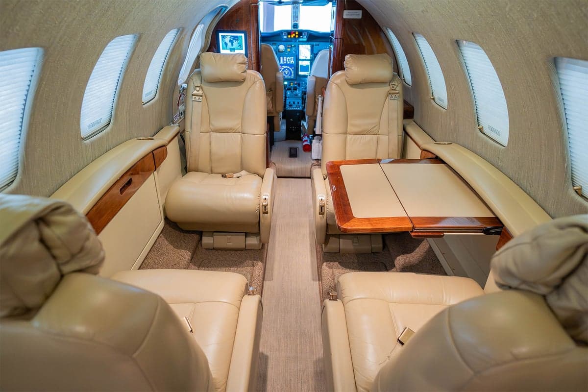 View of the aircraft interior showing the cabin seats and a table.