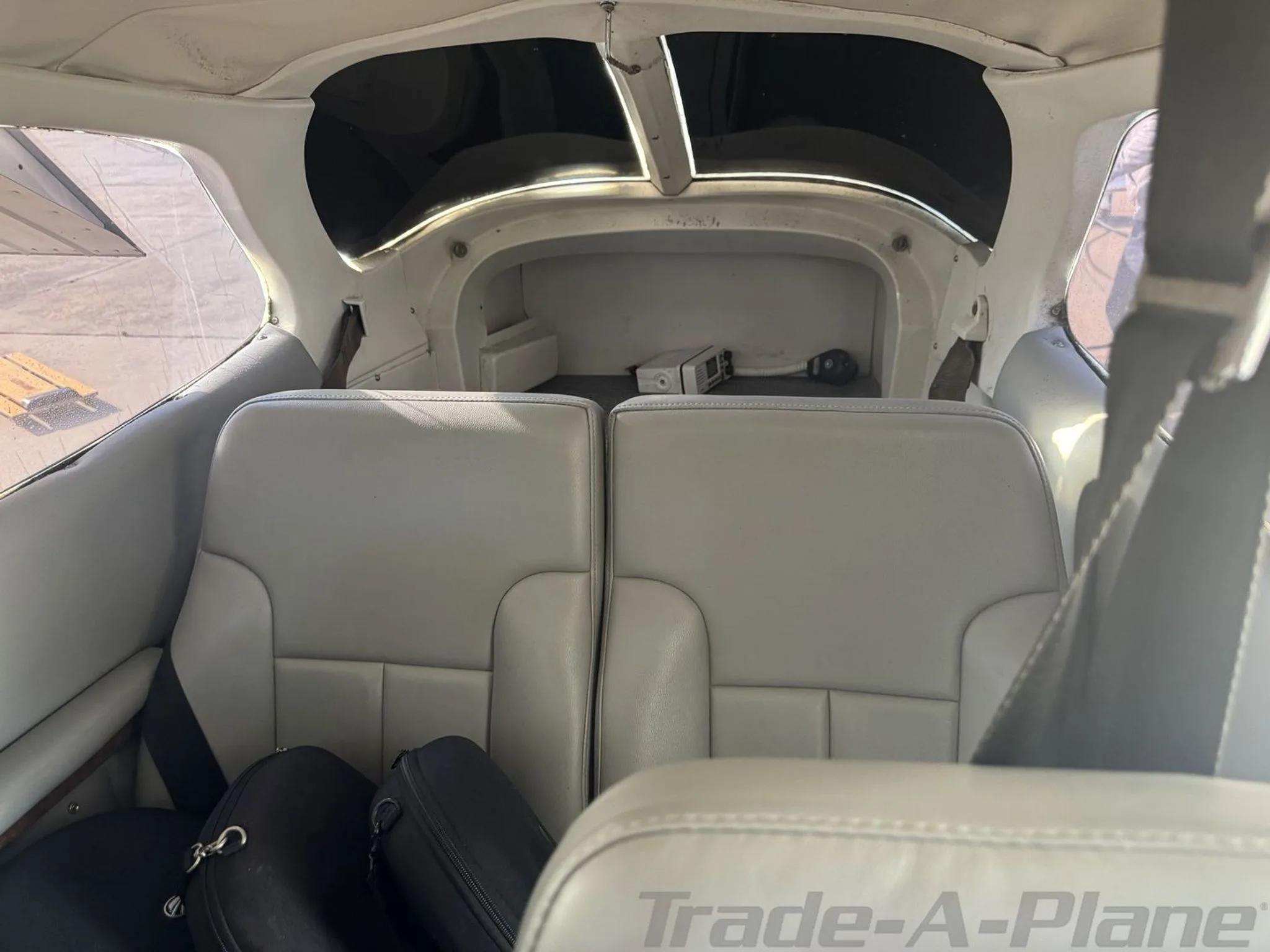 The rear light gray leather seats and baggage area of the Cessna 182 Skylane.