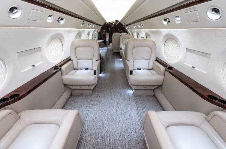 View of the aircraft's interior with cream-colored leather seats.