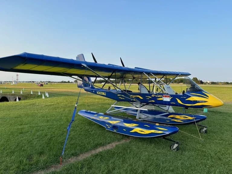 Air-Cam N300MJ on floats parked on the grass.