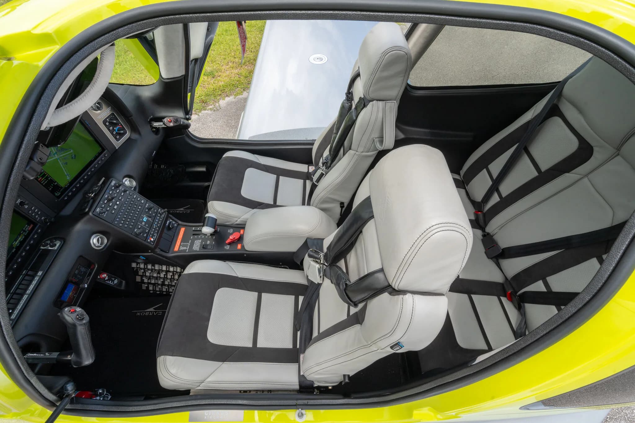 Overhead view of the Cirrus SR20 interior, showing the grey and black seats and the center console.
