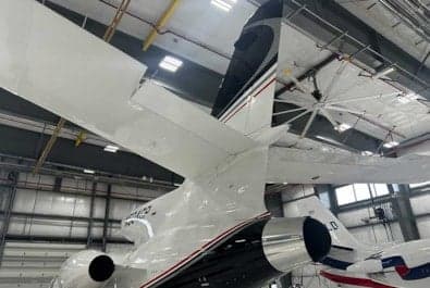 Rear view of the N504CP aircraft in a hangar.