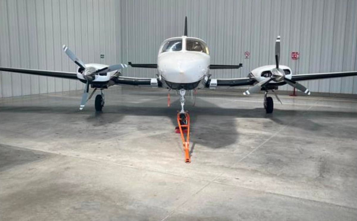 Front view of a Cessna 421 Golden Eagle aircraft in a hangar.