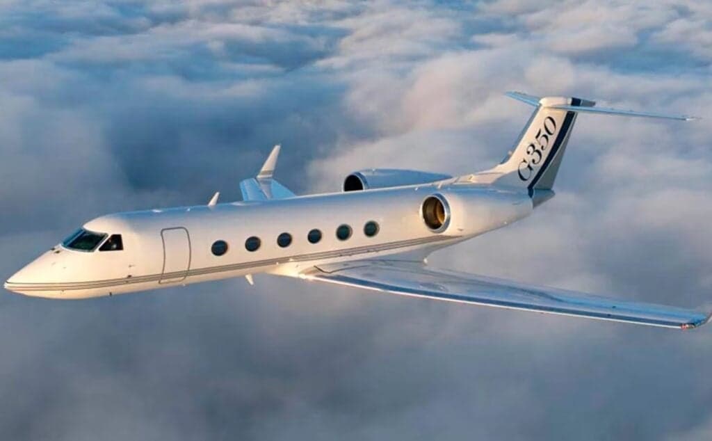 A Gulfstream G350 flying above the clouds.
