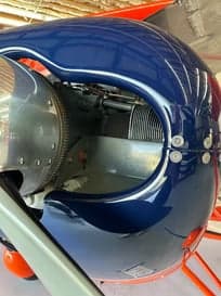 Close up of the front of an orange biplane.