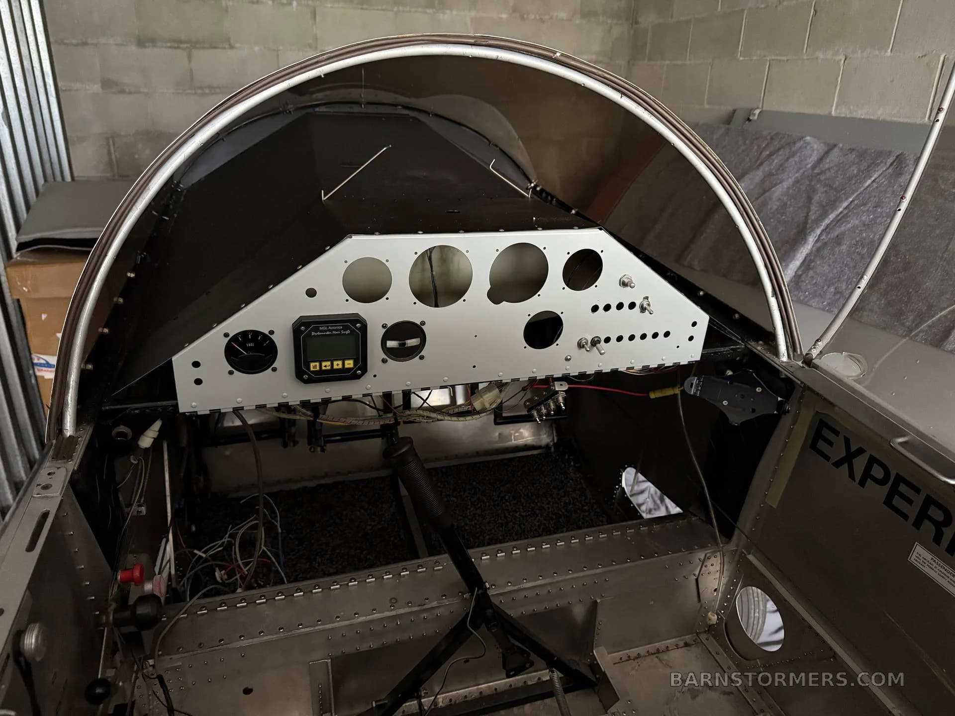 The partially assembled cockpit of an experimental aircraft, showing the instrument panel and internal structure.