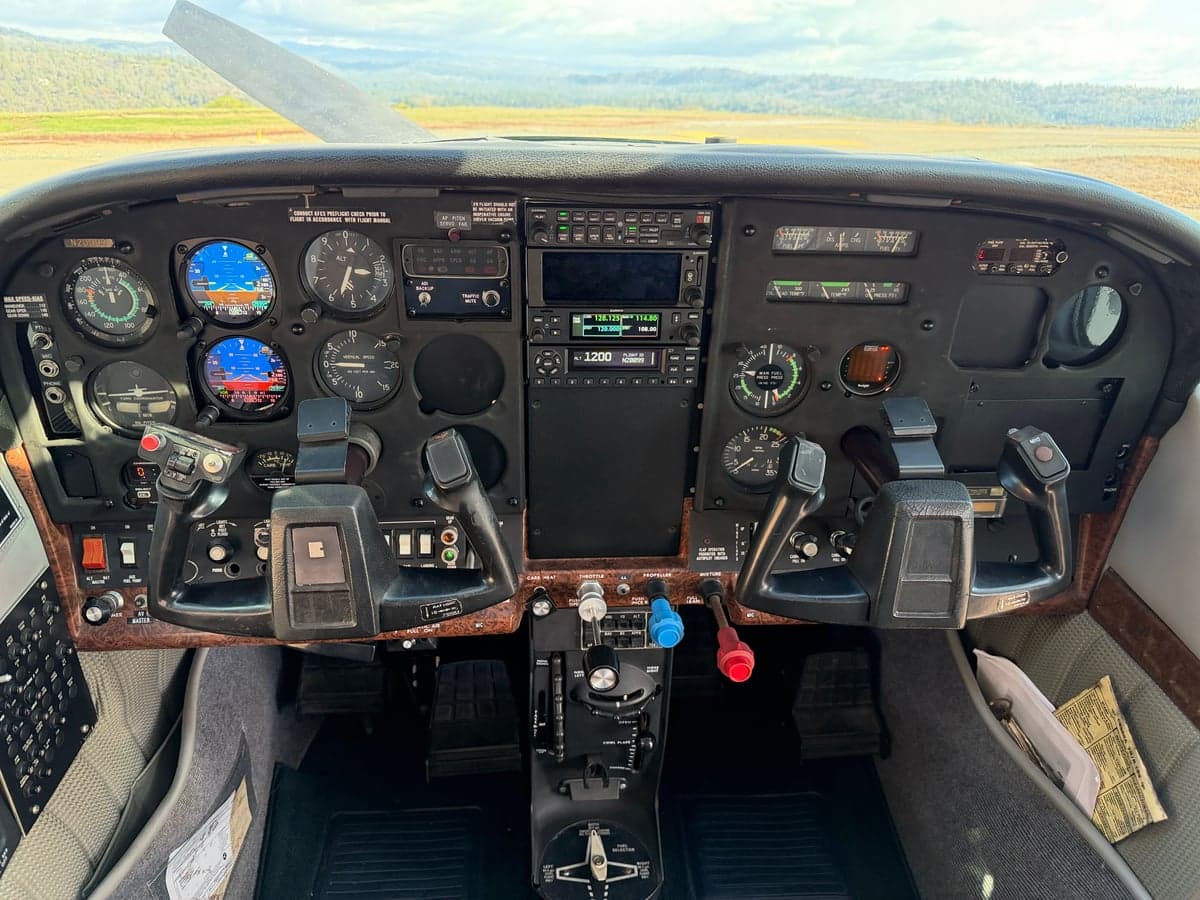 Wide view of the aircraft cockpit and instrument panel.