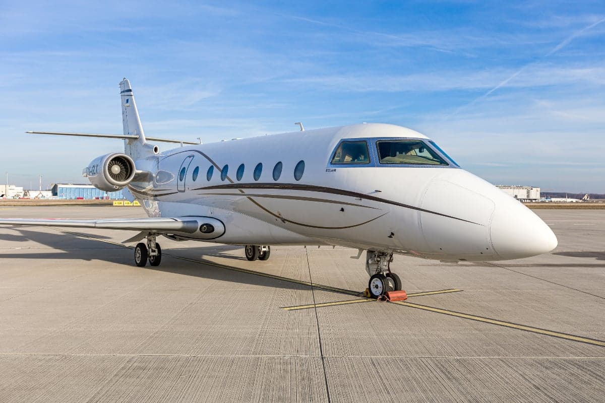Gulfstream G200 aircraft with the tail number OK-GLX parked on the tarmac.