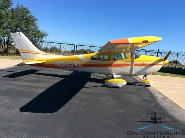 N8834X Cessna 172 Skyhawk with yellow and orange paint scheme, side view.
