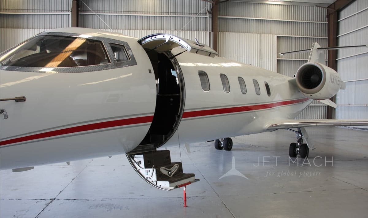 Side view of the N317EC aircraft with the entry door open, revealing the steps.
