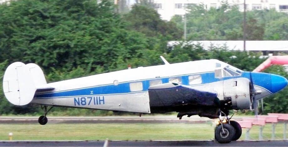 Beechcraft Model 18 aircraft N8711H on the ground with blue and white paint scheme.
