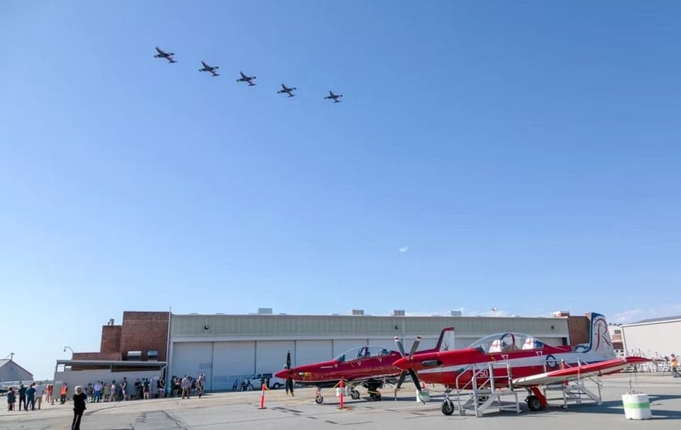 A23-050 aircraft on the ground with red and white paint scheme.