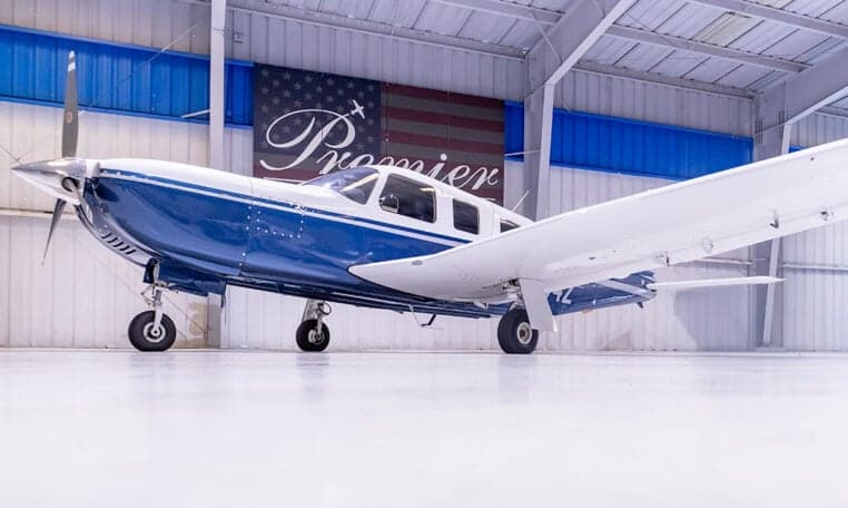 Piper PA-28-181 Archer II aircraft with blue and white paint scheme in a hangar, registration N4174Z.