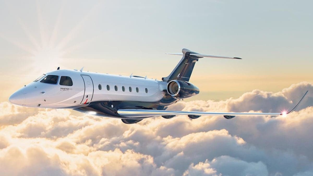 A Embraer Praetor 600 flying above the clouds.