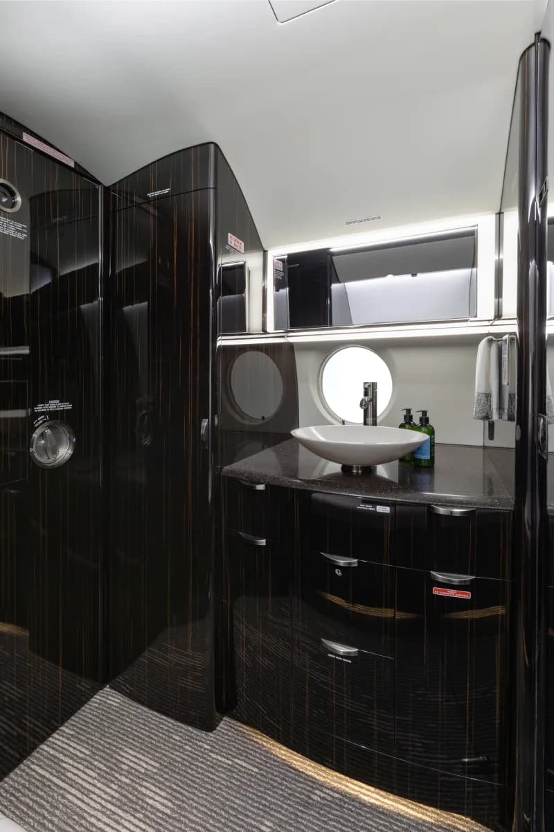 Lavatory with sink and dark wood cabinetry.