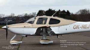 A Cirrus SR22 G3 Turbo aircraft with a white and gold paint scheme, side view.