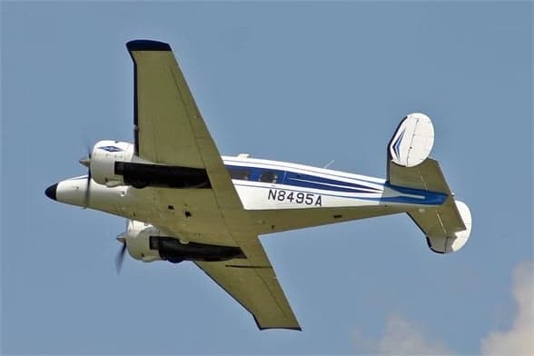 Beechcraft Model 18 with registration N8495A in flight.