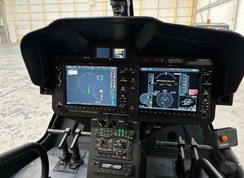 View of the helicopter cockpit with modern avionics and displays.