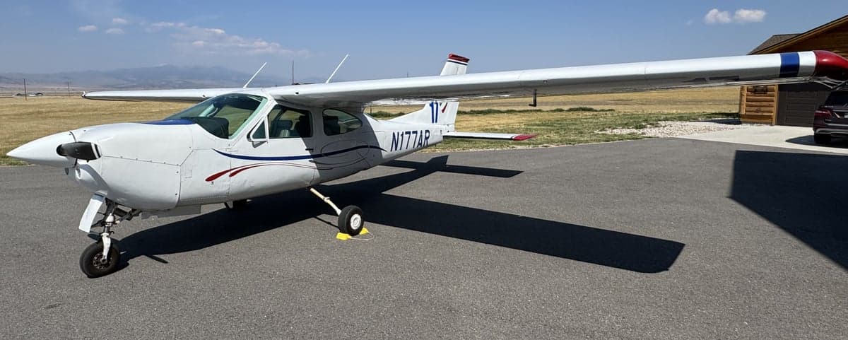 N177AR Cessna parked on the tarmac with mountains in the background.