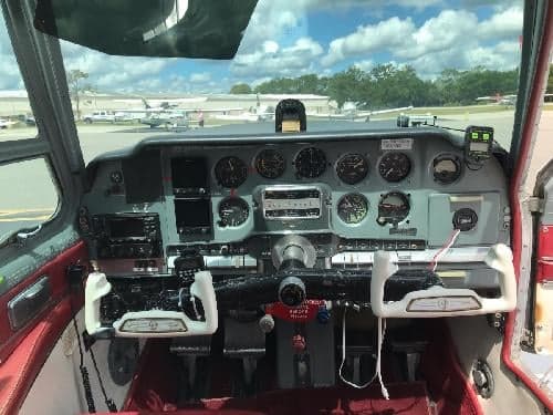 The cockpit of the aircraft features a gray instrument panel and white yokes.
