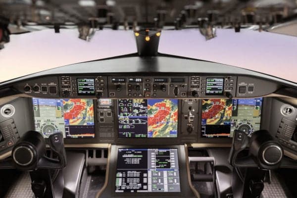 The cockpit of a Global Express aircraft with multiple display screens.