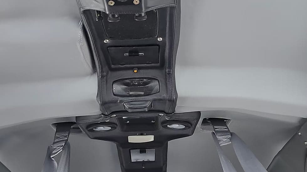 Overhead view of the Cessna Caravan's interior, showing the ceiling panel and seatbelts.