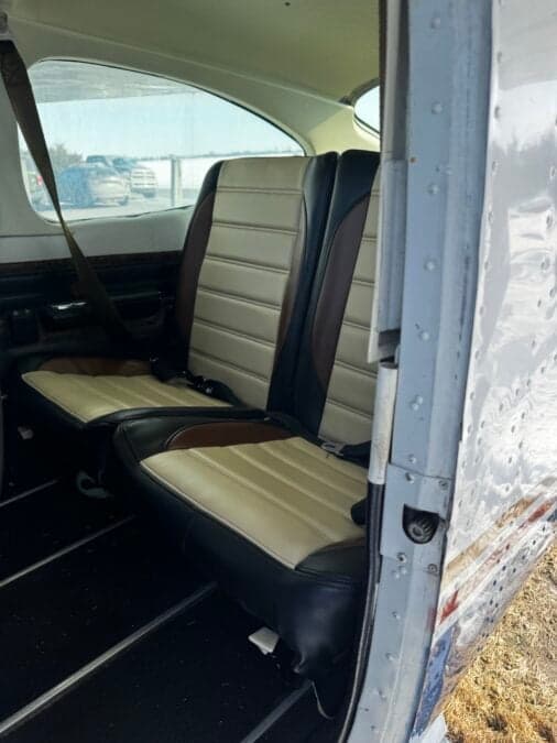 The rear seats of the Cessna aircraft, showing the seatbelts.