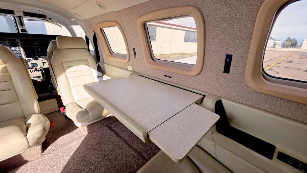 Interior of the aircraft with seats and a fold-out table.