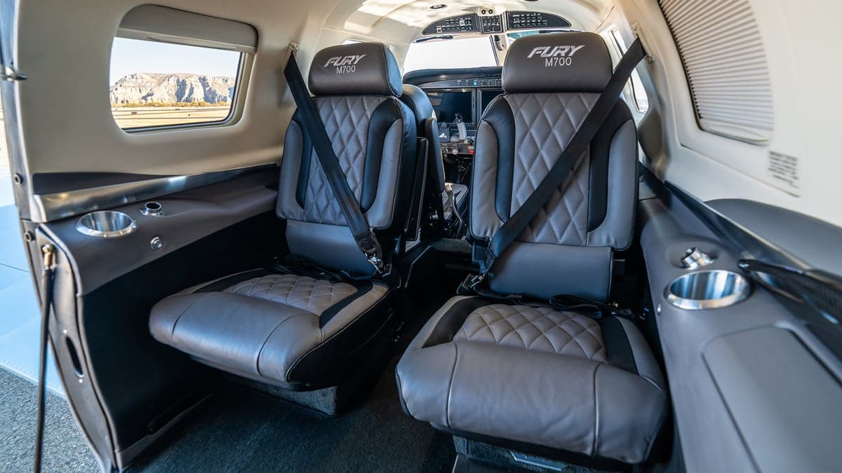 View of the aircraft's cabin seats with seatbelts.