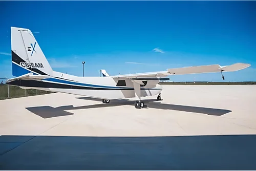 A white and blue twin engine aircraft is parked on the tarmac on a sunny day.