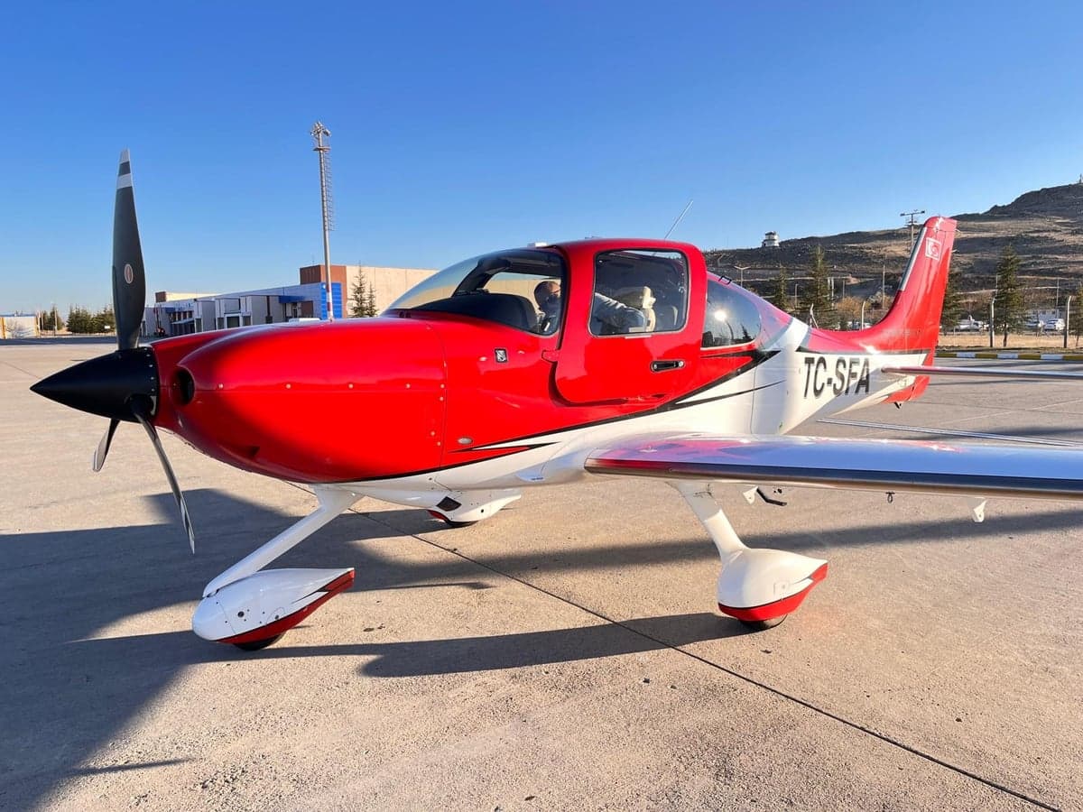 TC-SFA aircraft with red and white paint scheme on the tarmac.