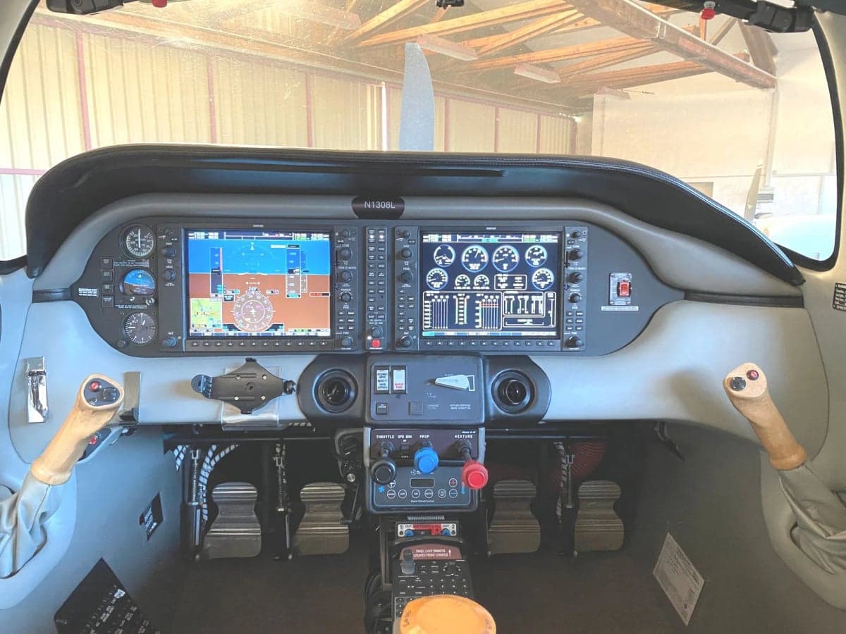A close-up of the Cirrus Columbia 400's door and front section, showing the registration N1038L.