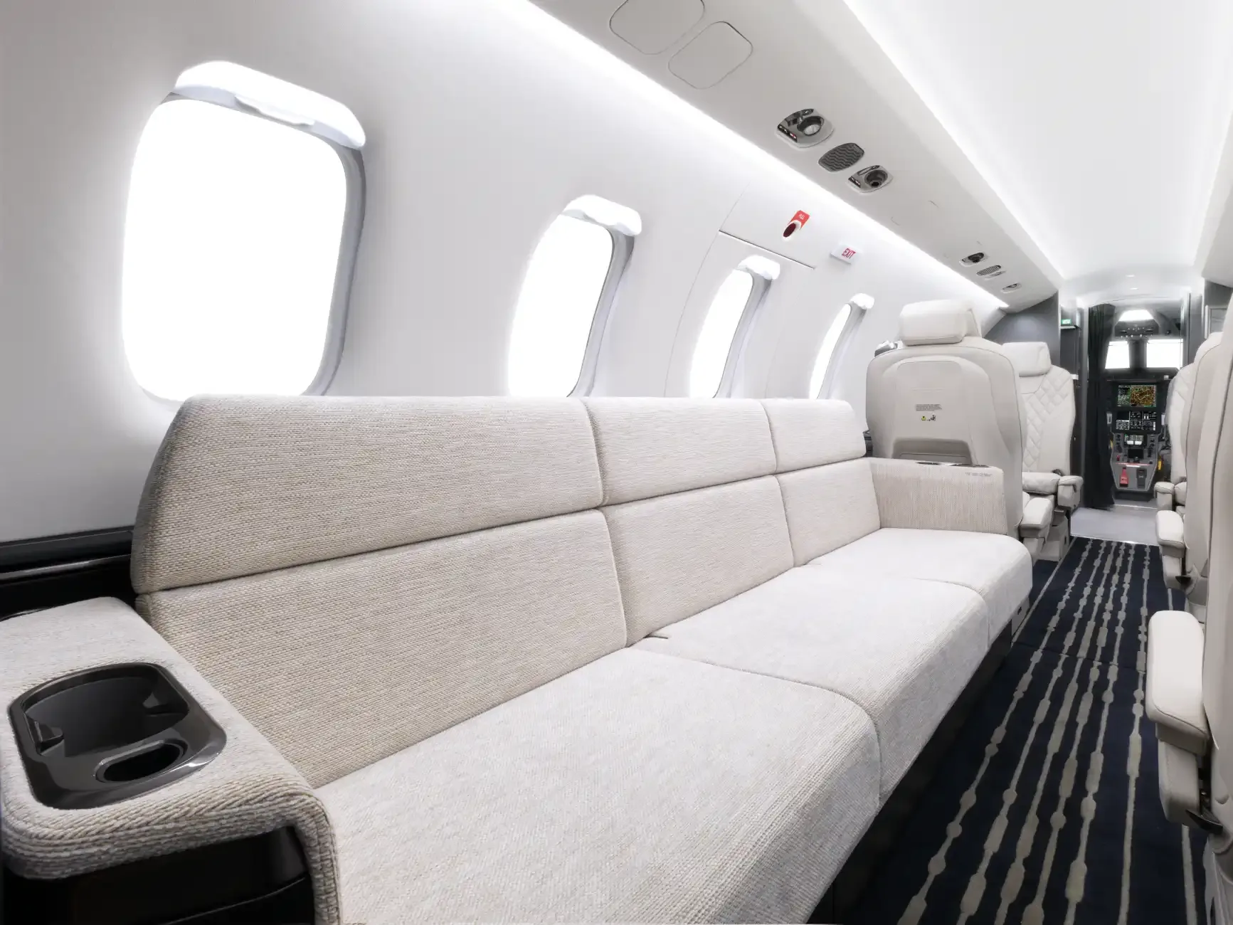 View of the aircraft interior with a couch and seating area.