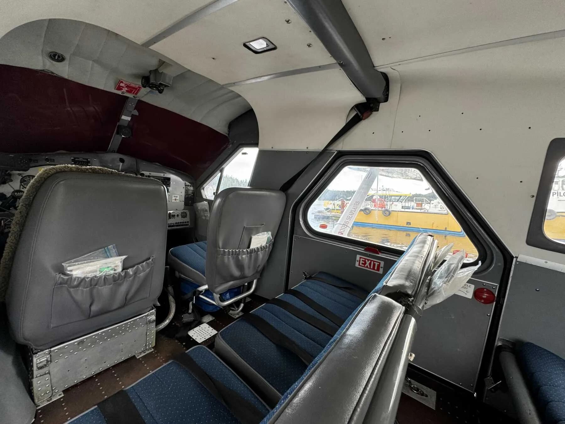 View of the front and rear passenger seats inside the aircraft cabin.