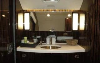 A lavatory sink and mirror in the aircraft interior.