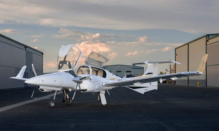 Diamond DA62 aircraft with open doors parked on the tarmac.