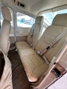 The rear seats of the Cessna 182 Skylane, upholstered in light tan leather.