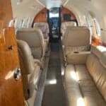 Hawker 750 cabin seating with a table and monitor.