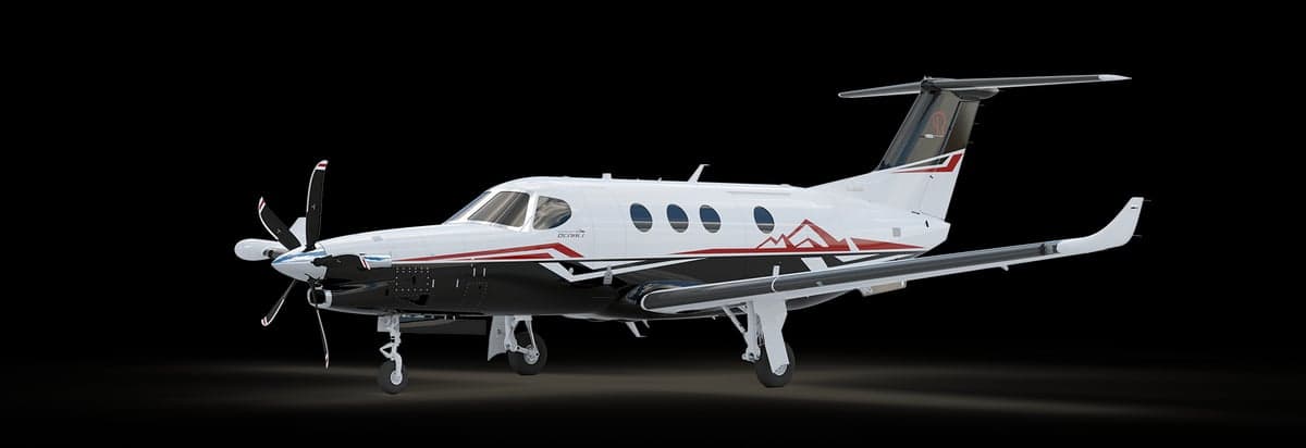 A Pilatus PC-12 NGX aircraft with a black, white, and red paint scheme.