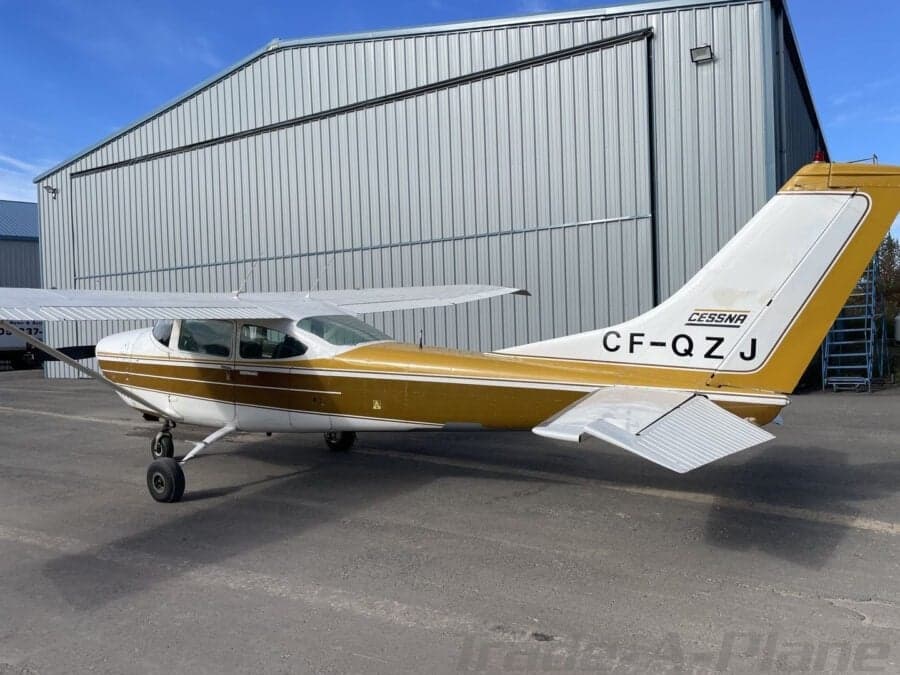 Cessna 182 Skylane parked in front of a hangar.