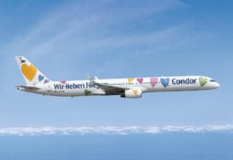 A Condor Boeing 757 in flight with a special livery featuring colorful hearts.