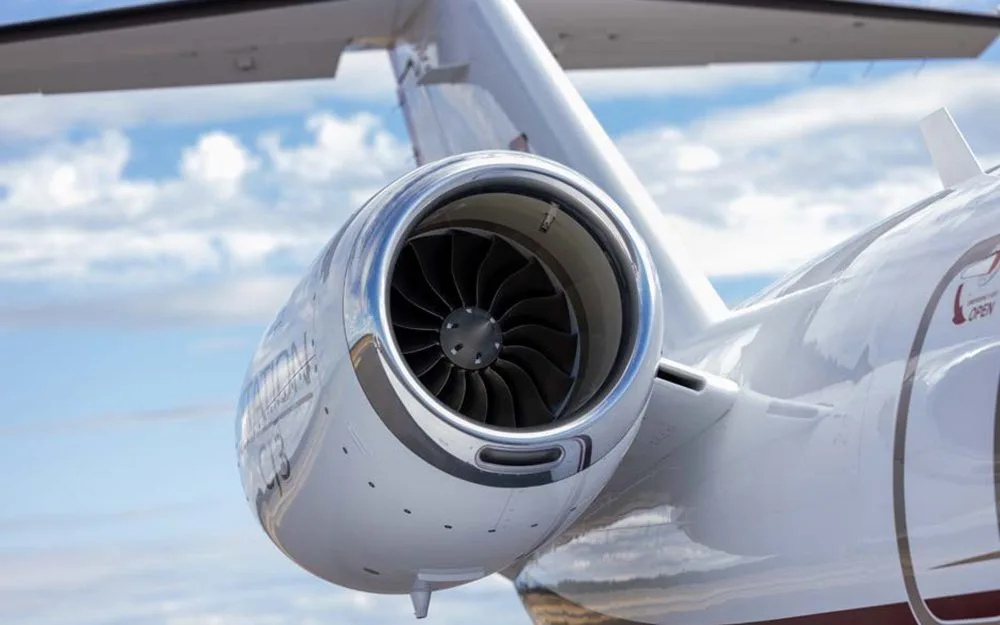 A close-up view of the polished engine nacelle and fan blades of a Cessna Citation CJ3 jet.